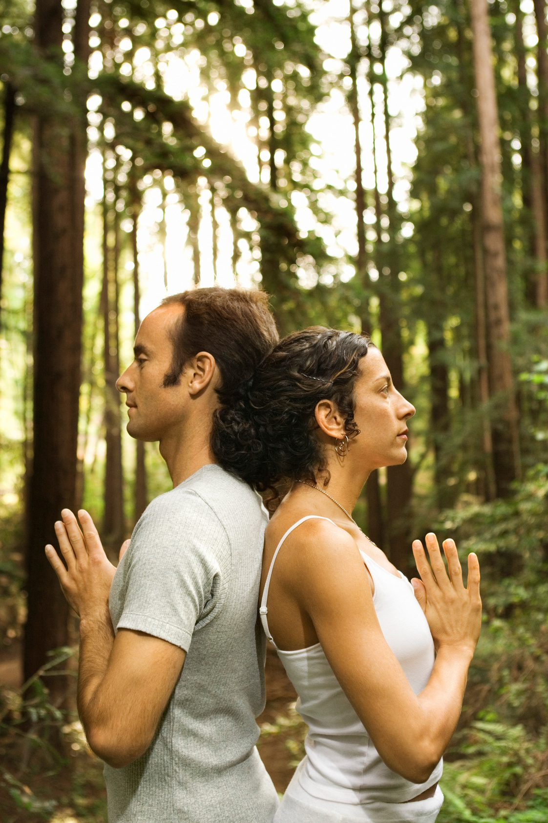 Couple meditating in forest