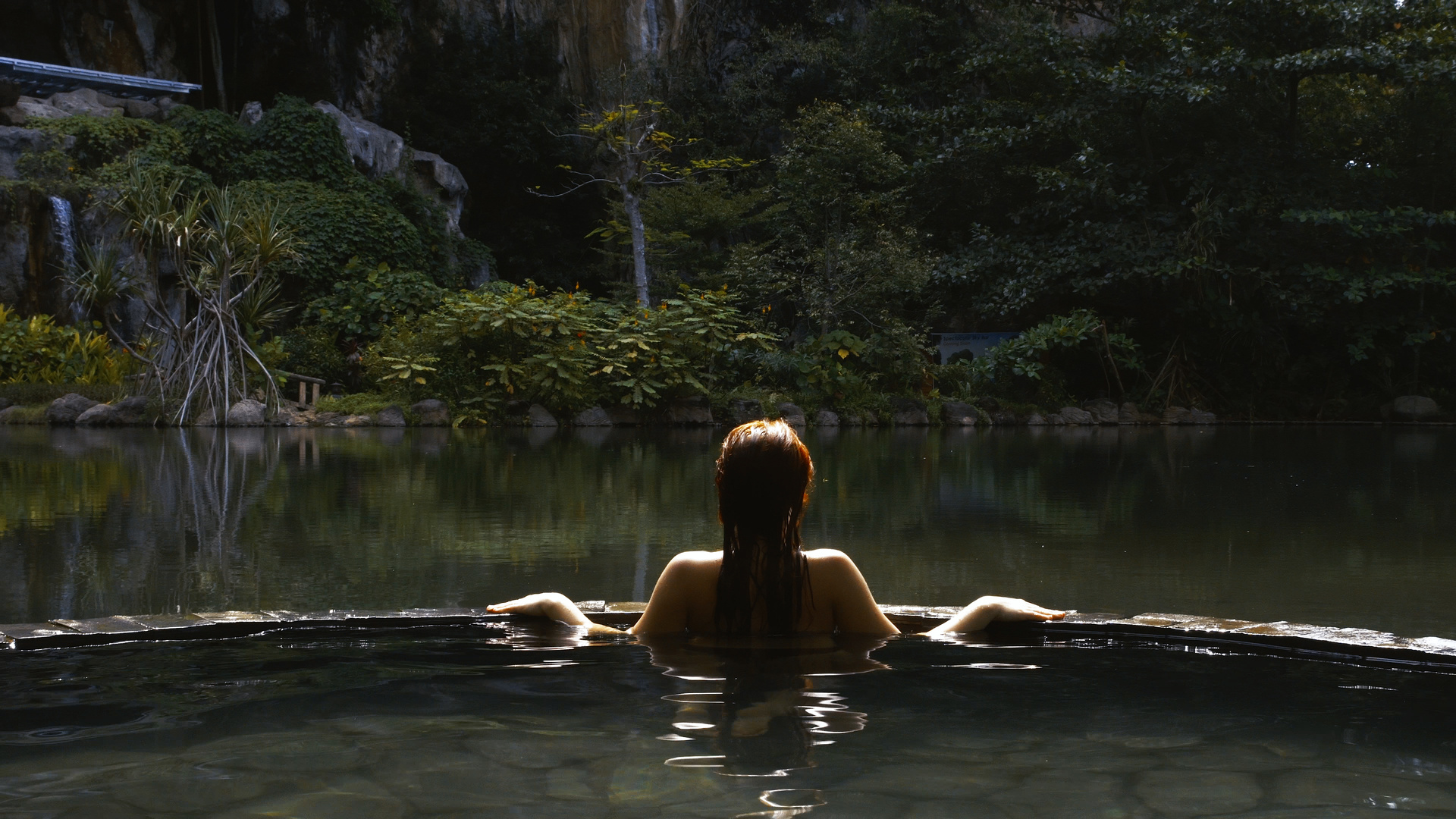 Hot tub in the jungle. Woman relaxing in spa retreat